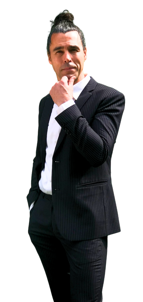 a photo of Davido, the English teacher dressed in a dark pin-striped suit and a white shirt. His hair is done up in a tight coil on the top of his head. He's holding his jacket with the right hand whilst he's smiling and looking to the right, to the area of content.