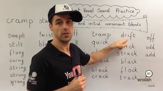 An English class in Hong Kong on short vowel sounds by a teacher with a cap in front of a whiteboard